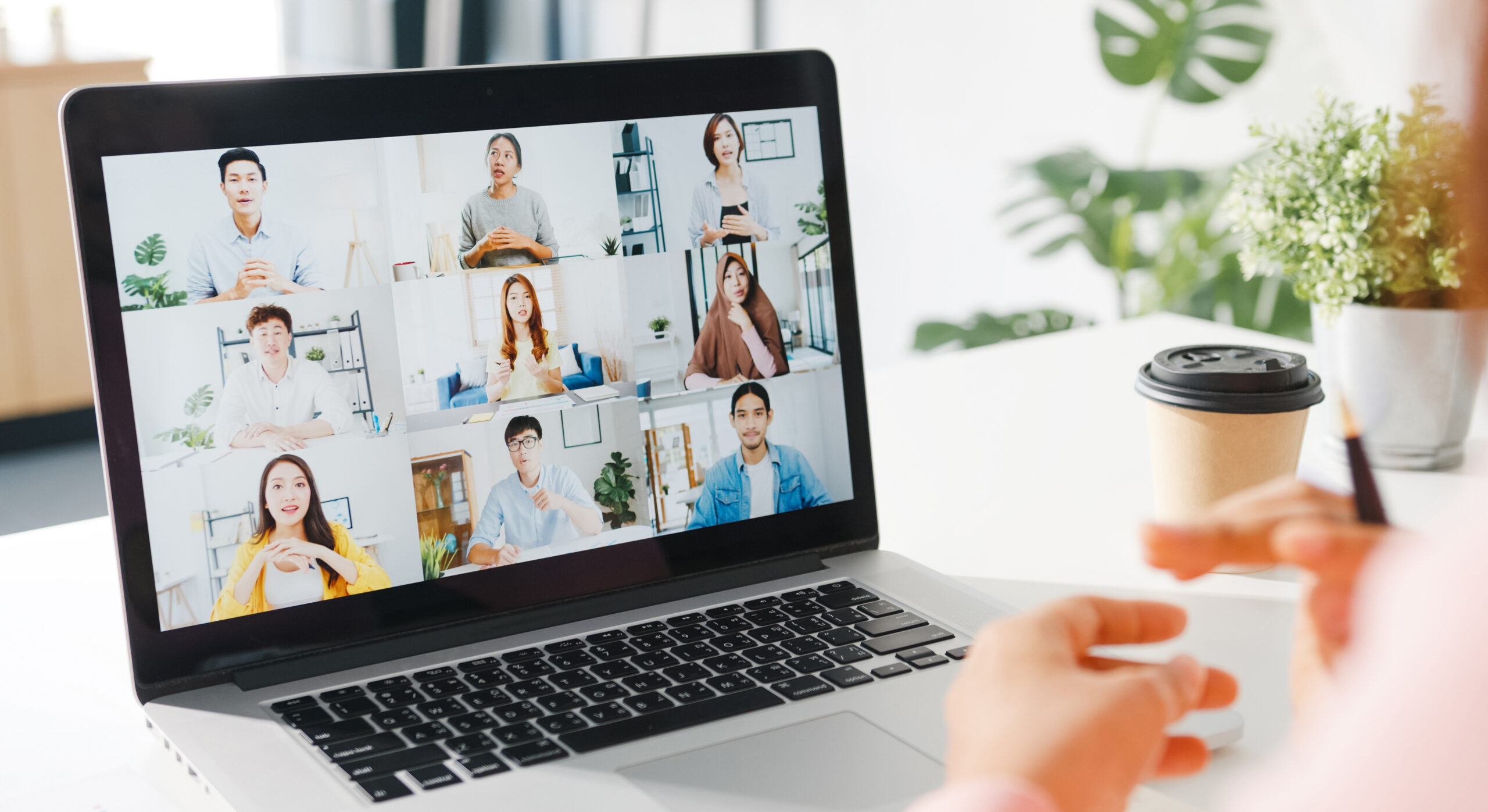 Young Asia businesswoman using laptop talk to colleague about plan in video call meeting while work from home at living room. Self-isolation, social distancing, quarantine for corona virus prevention.