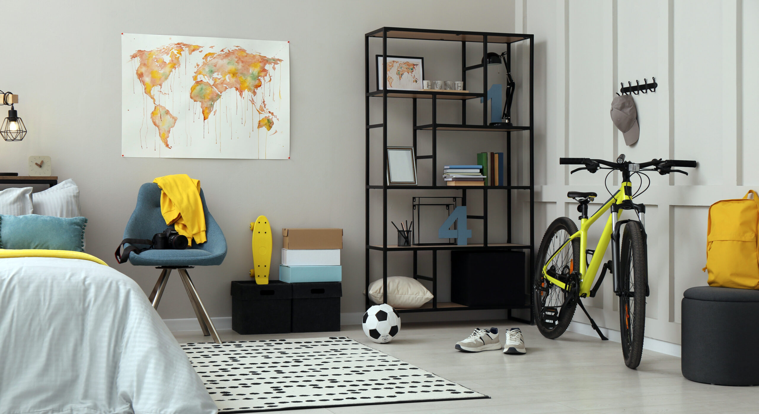 Stylish teenager's room interior with comfortable bed and sports equipment