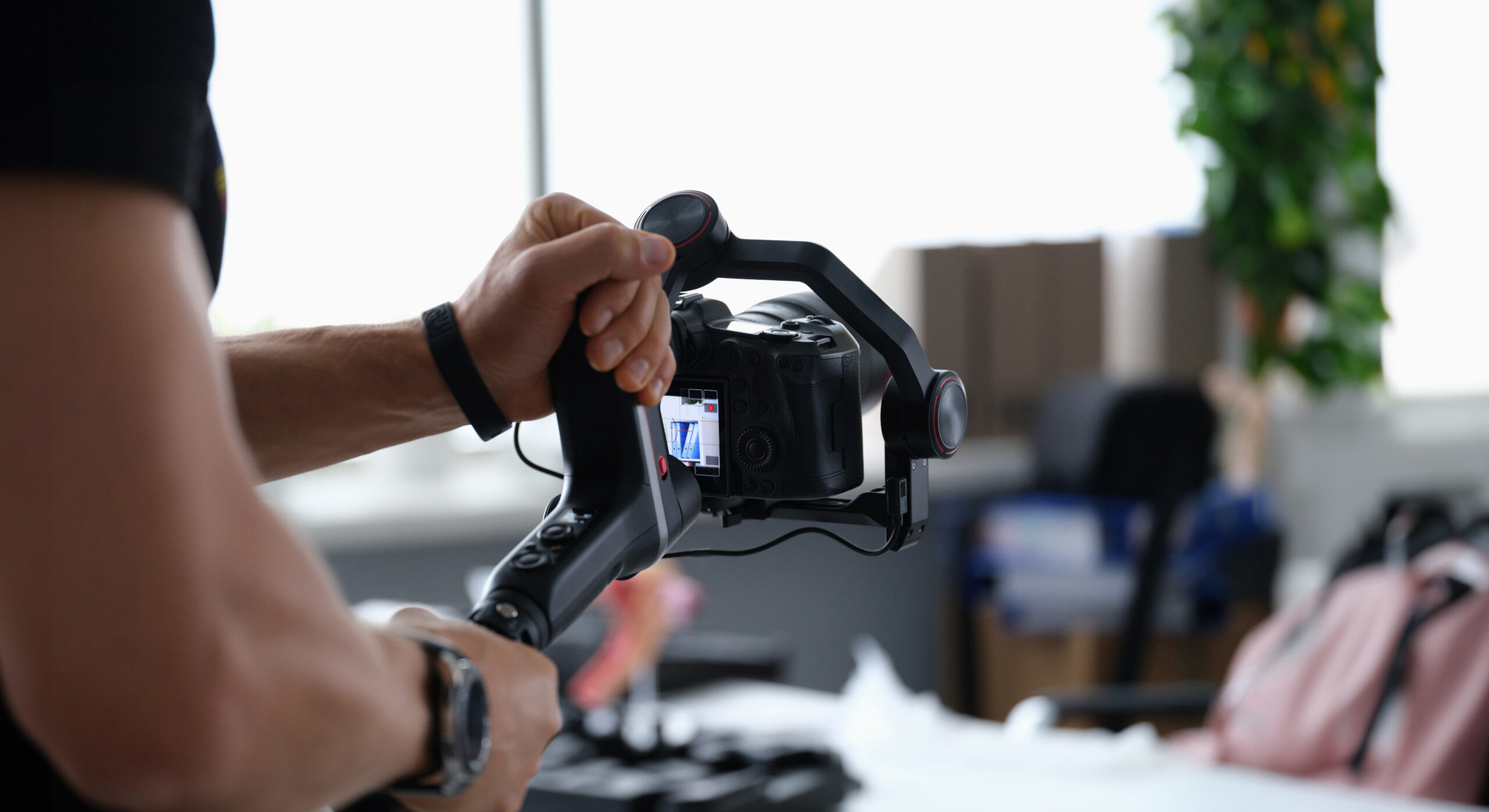 Photographer shooting video on camera from tripod closeup. Professional photographic equipment concept