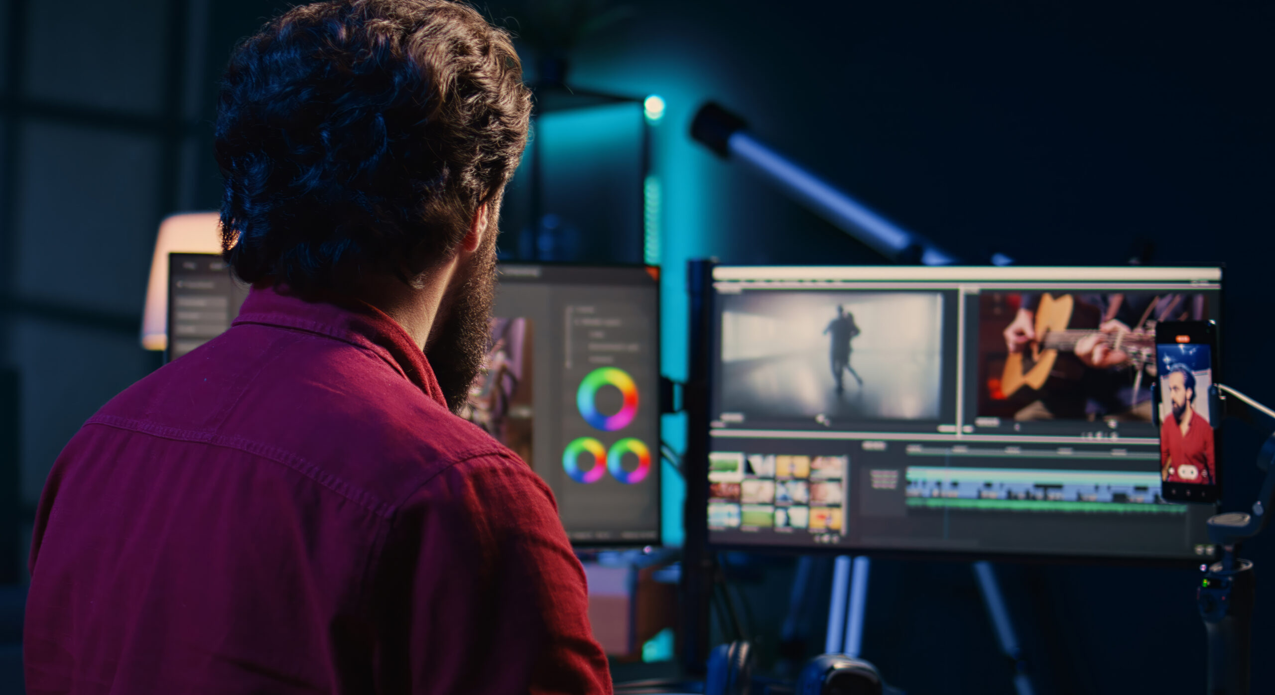 Video editor using smartphone to film tutorial on how to polish raw footage and apply modern editing techniques. Videographer recording internet guide on professionally adjusting clips